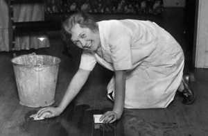 Smiling Housewife Scrubbing Floor